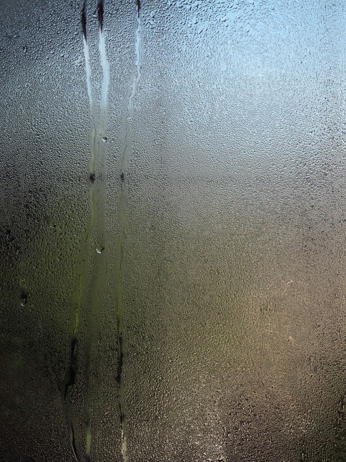 Close-up pattern of water droplets on a glass surface