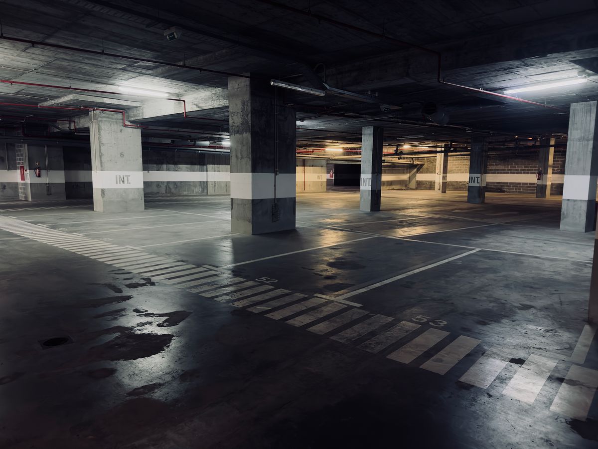 Concrete parking floor with reflective wet patches